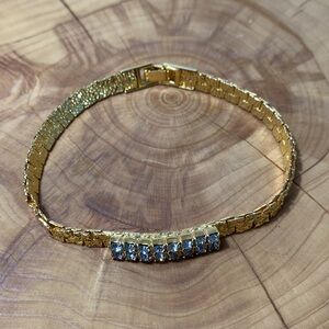 Gorgeous nugget style gold tone bracelet with clear rhinestones. Foldover clasp